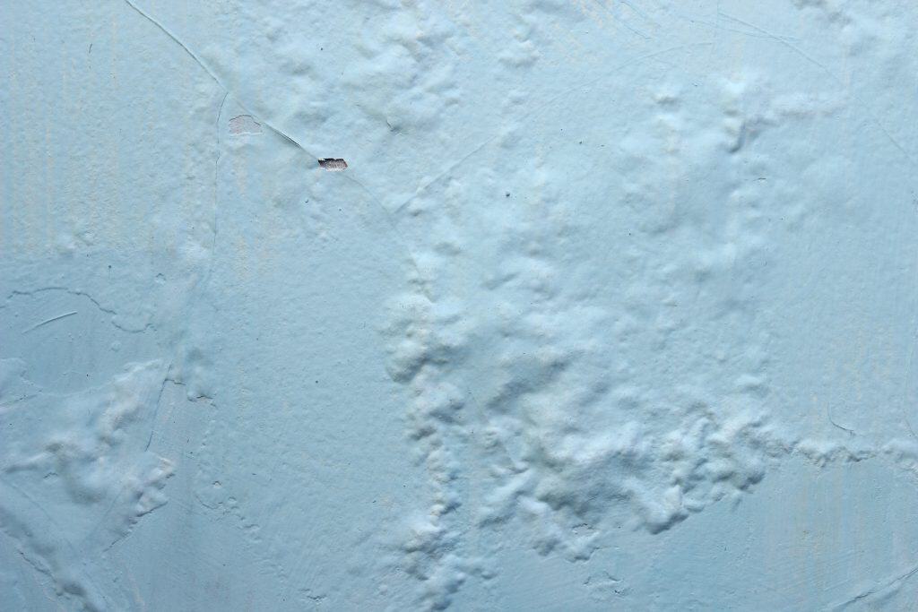 Bubbling and blistered paint on a Hermanus coastal home caused by damp, salt air and poor adhesion